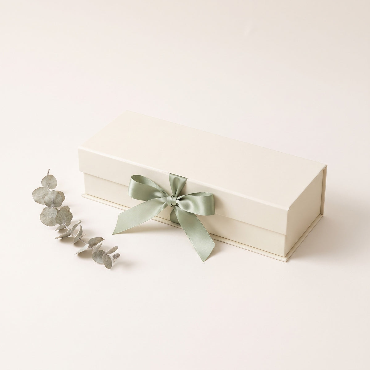 Cream keepsake gift box tied with a sage green ribbon