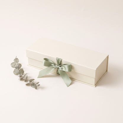 Cream keepsake gift box tied with a sage green ribbon