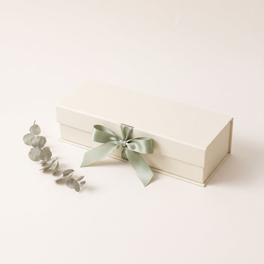 Cream keepsake gift box tied with a sage green ribbon
